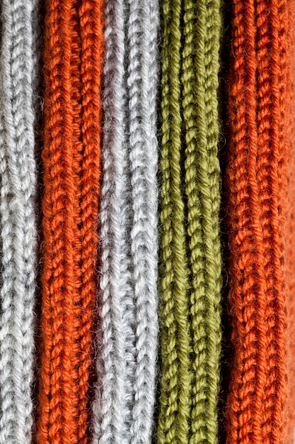 Orange, green and grey wool knitted texture.