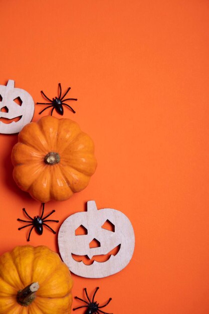 Orange halloween background with pumpkins and spiders