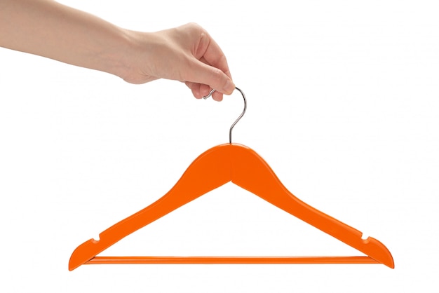 Photo orange hanger in woman hand isolated.