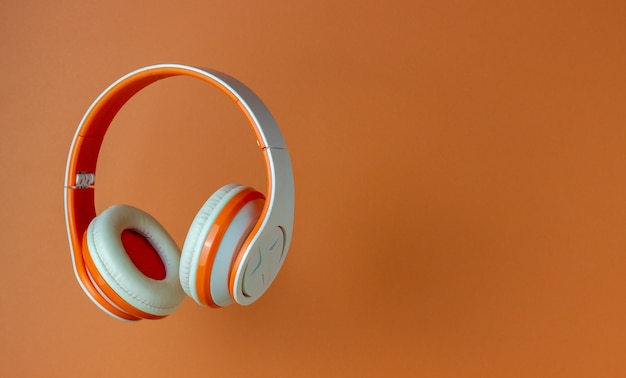 Orange headphones on an orange wall