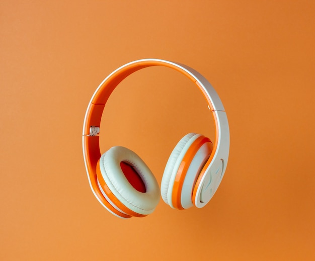 Orange headphones on an orange wall