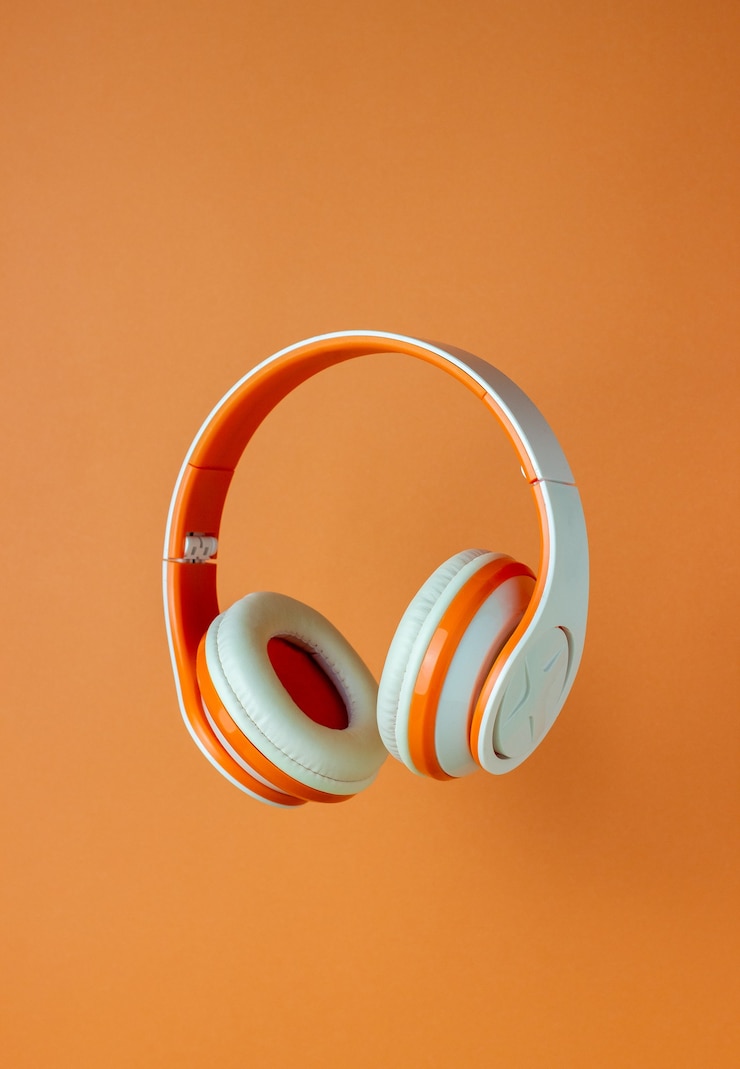 Photo orange headphones on an orange wall