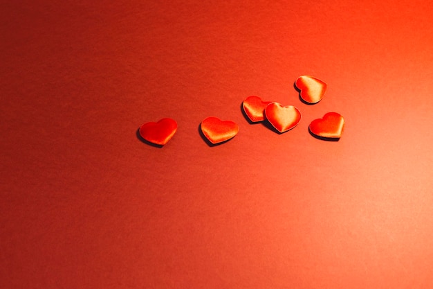 Orange heart shapes over colored background