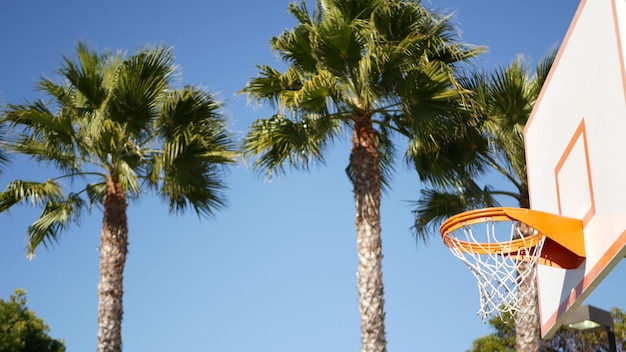 Orange hoop net and backboard for basket ball game basketball court outdoors
