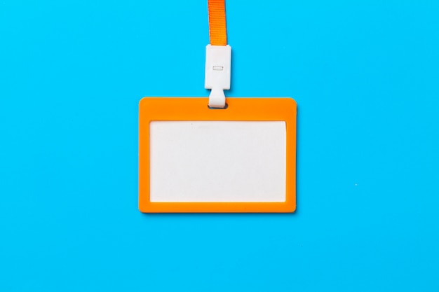 Orange id card with copy space on blue paper