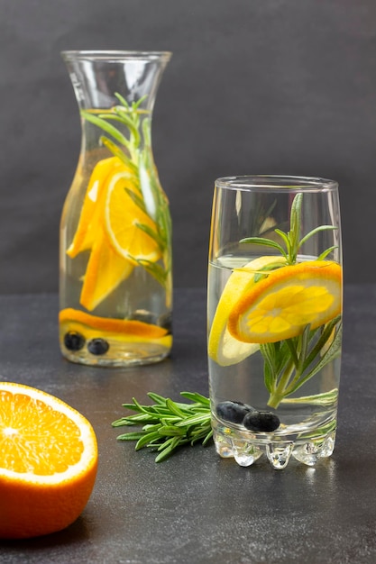 Orange infused water in glass and bottle