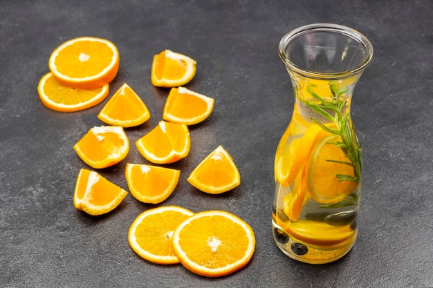 Photo orange infused water in glass bottle