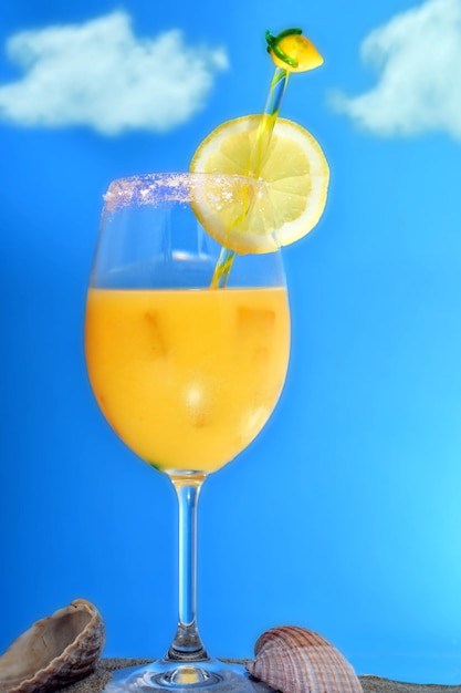 Foto cocktail di succo d'arancia sulla sabbia della spiaggia