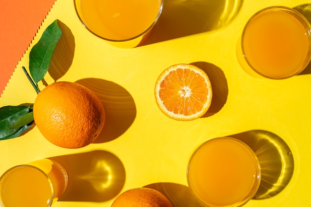 Photo orange juice from above on colored walls.