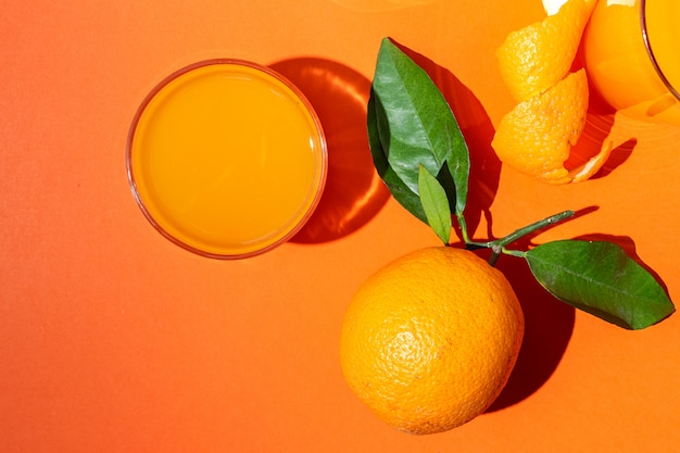 Photo orange juice from above on colored walls.