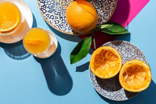 Photo orange juice from above on colored walls.