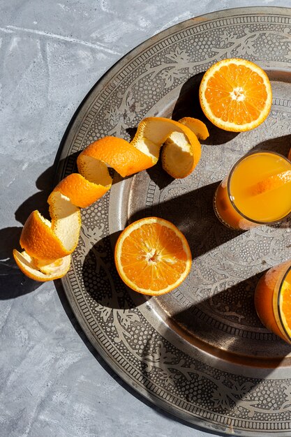 Photo orange juice from above on gray walls.