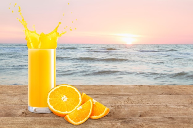 orange juice in glass on the beach table