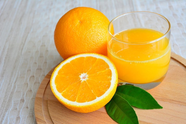 orange juice in glass on cutting board, close-up