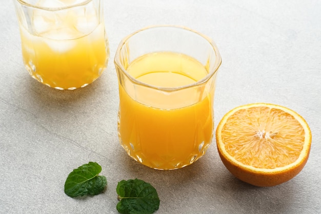 Orange juice in glass with fresh fruits on the table Selective focus and blurred background