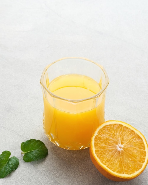 Orange juice in glass with fresh fruits on the table Selective focus and blurred background