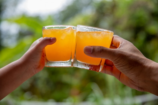 Orange juice grips on natural background