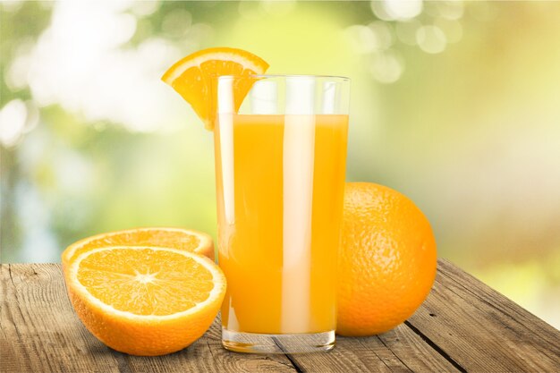 Orange juice and slices of orange on background