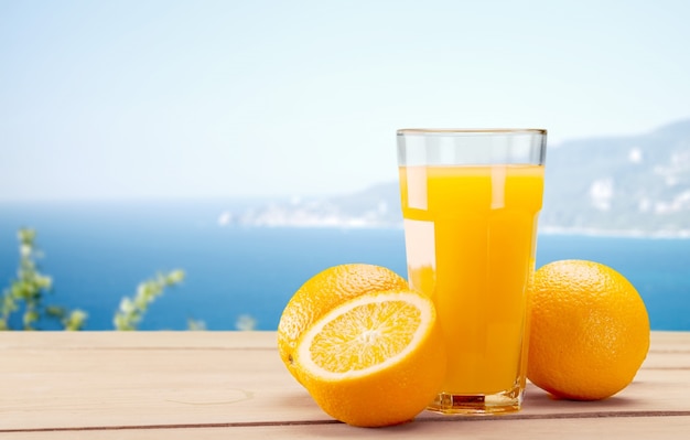 Orange juice and slices of orange on background