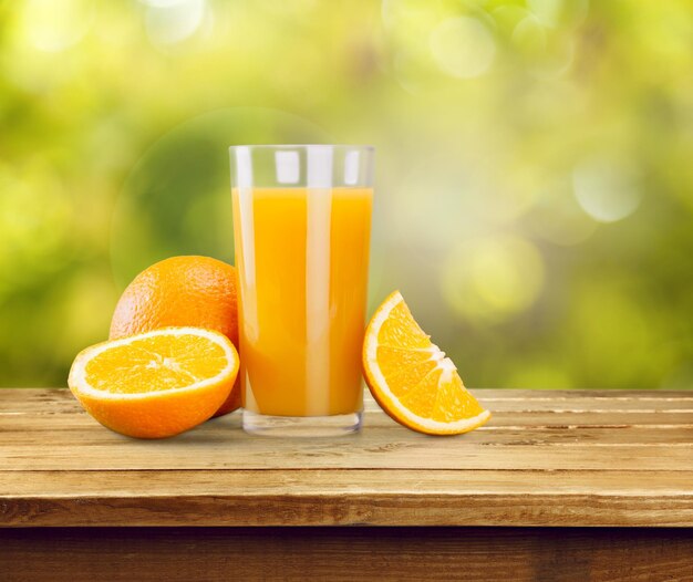 Orange juice and slices of orange on background