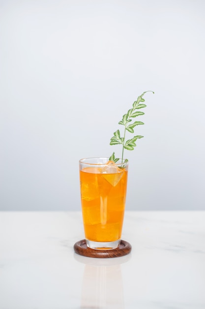 Orange juice soda mix on marble tile background.