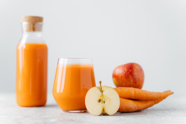 Orange juice on table against white background