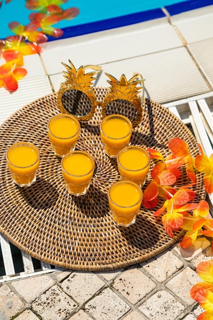 Orange juice with orange sacs and slices fruits isolate orange juice glass jar shot