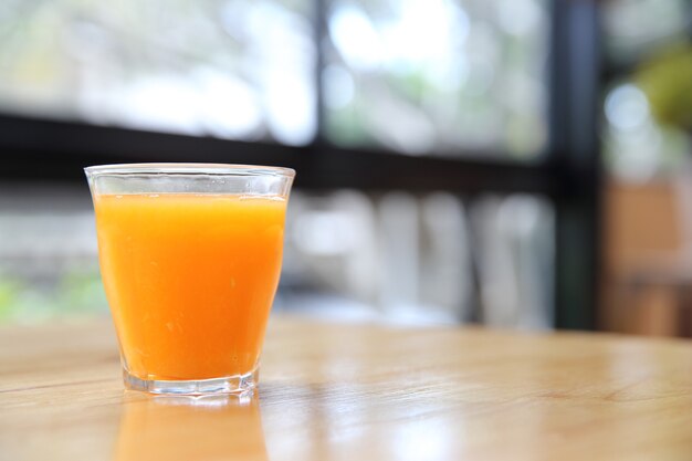 Orange juice on wood background