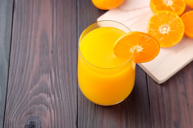 Orange juice on wooden background