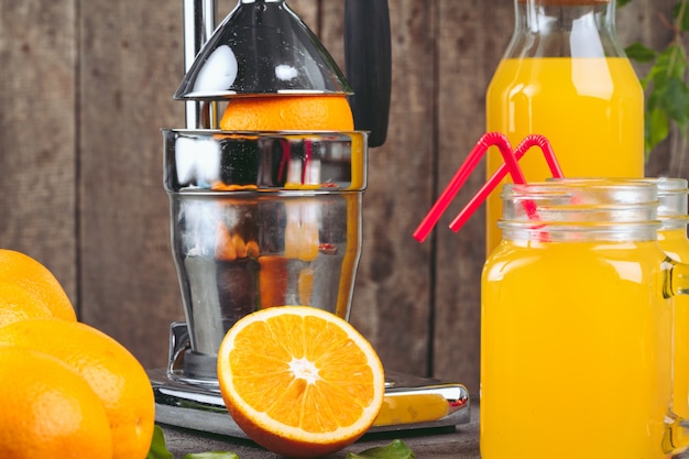 Orange juicer apparatus on kitchen table close up