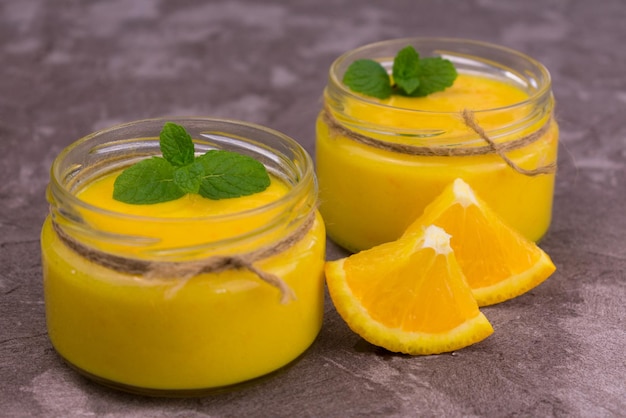 Orange Kurd in low jars Orange summer refreshing dessert Closeup