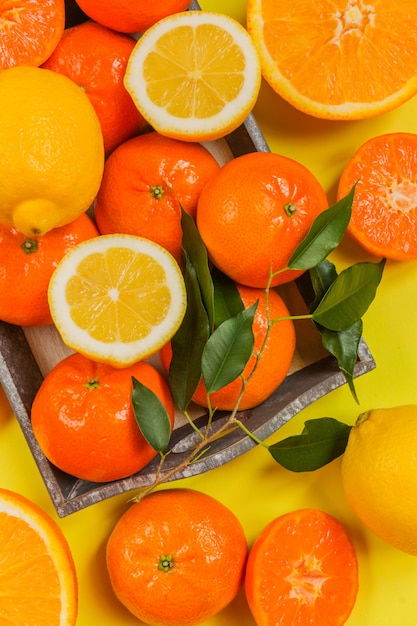 Orange, lemon, citrus fruits flat top view pattern on yellow background