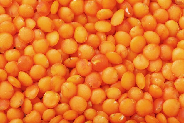 Orange lentils in full-screen close-up.