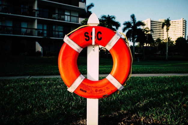 Orange life belt hanging on pole