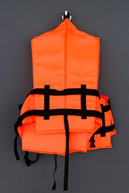 Orange life jacket on grey background