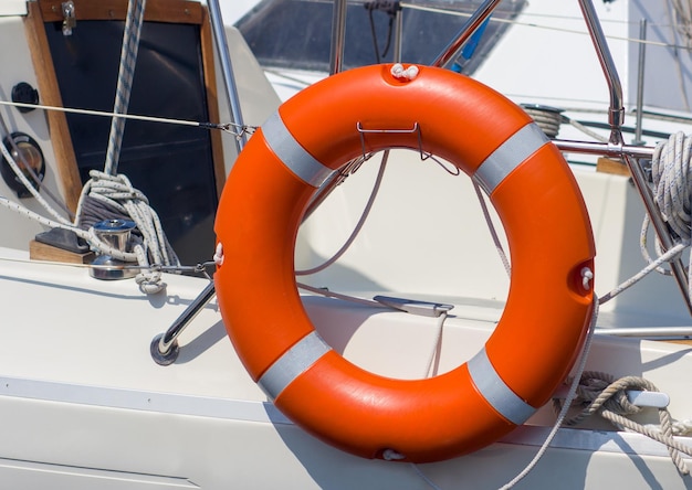 Orange lifebuoy on a yacht on a summer day Safety on the water Tourism cruises