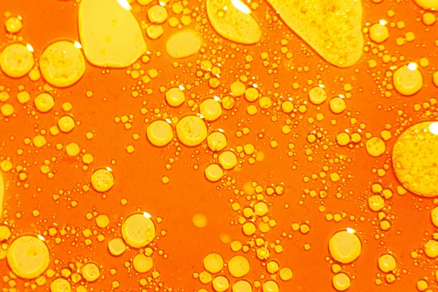 Orange liquid with bubbles on the surface