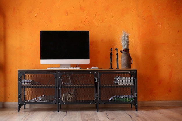 Orange living room interior with black metal tv stand and\
monitor. modern room design