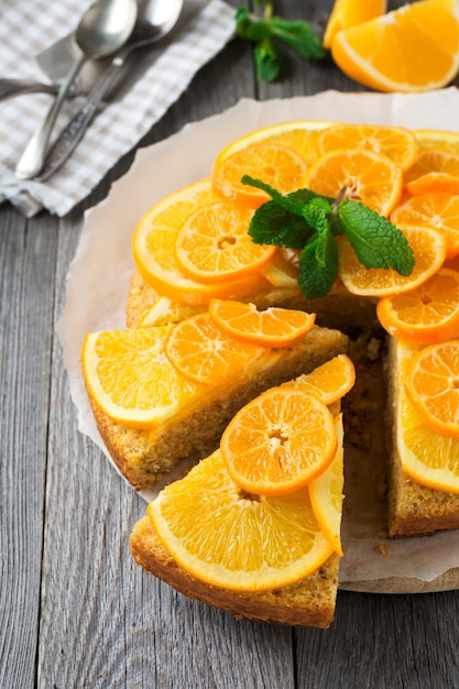 Orange and mandarin cake with polenta, upside down on the old wooden