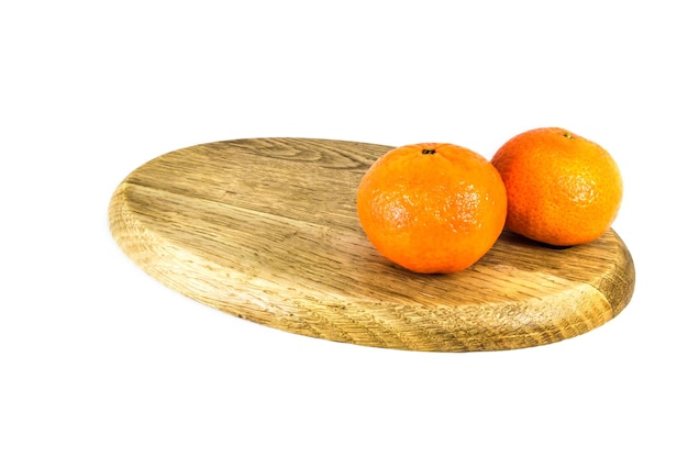 Orange mandarins or tangerines on cutting board isolated on white background Closeup photos of fresh citrus fruit