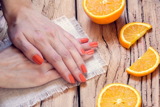 Orange manicure and oranges