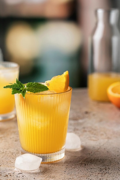orange and mint cocktails soft drinks on bar with text space