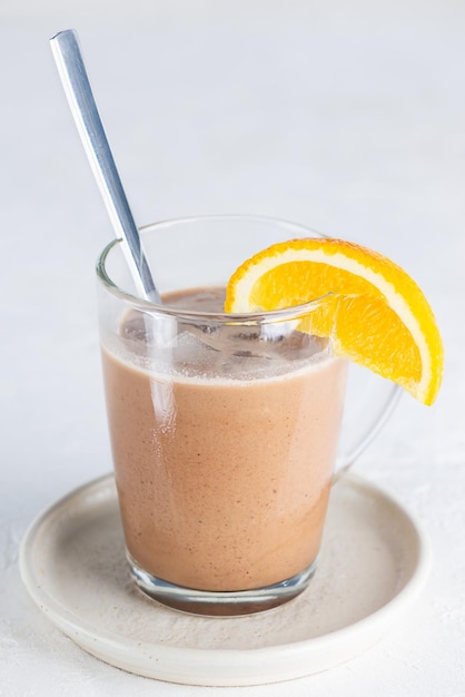 Orange mocha coffee with chocolate and coconut milk in a glass cup