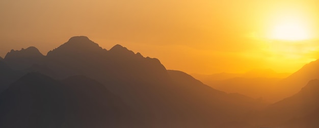 Orange natural landscape  misty mountains at sunset