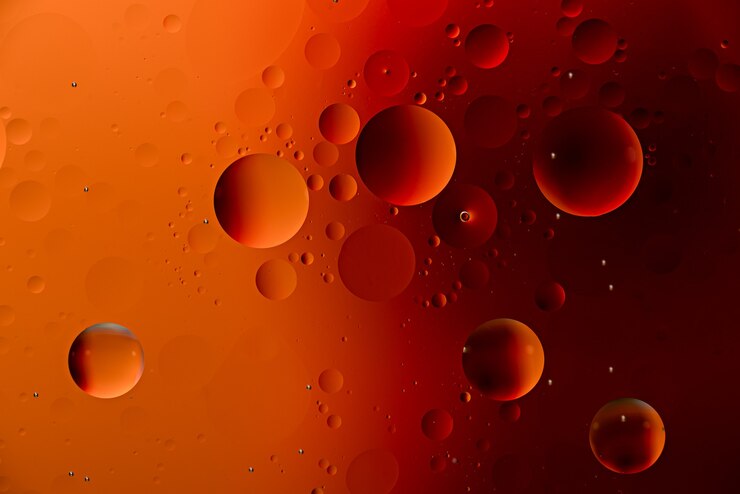 Orange oil drops on water surface with effect duotone. art background concept