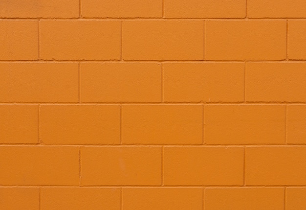 Orange painted brick wall texture and background