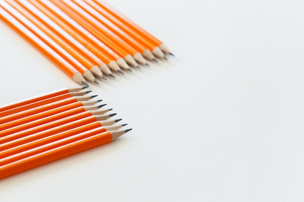 Orange pencils close up isolated on white