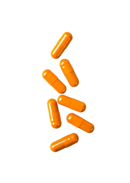 Orange pill capsules isolated on white surface