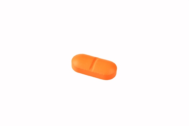 Orange pills on a white background close-up. Insulators