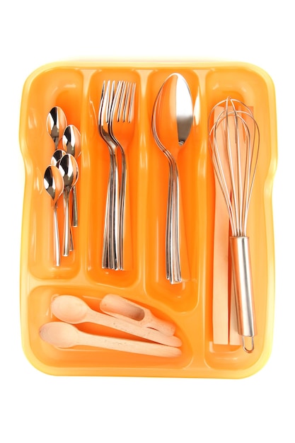 Photo orange plastic cutlery tray with checked silver cutlery and wooden spoons isolated on white